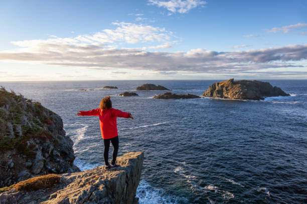 istock Woman by the ocean cliff 1130189397