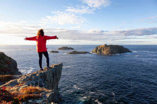 istock Woman by the ocean cliff 1130189398