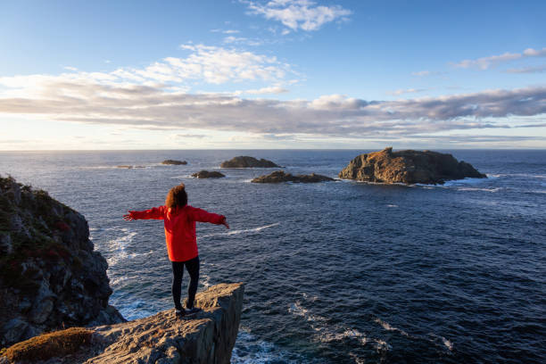 istock Woman by the ocean cliff 1130189521