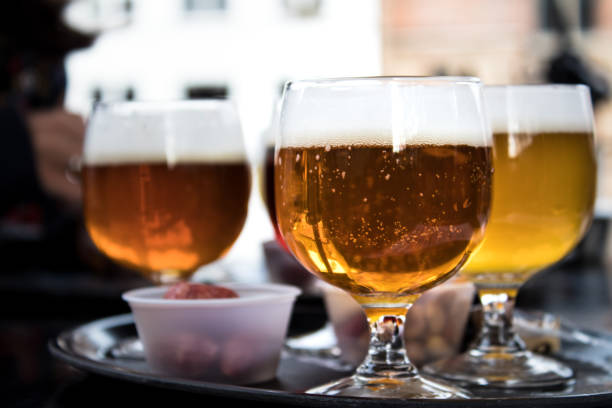 three cups of belgium beer, amber and white - amber beer imagens e fotografias de stock