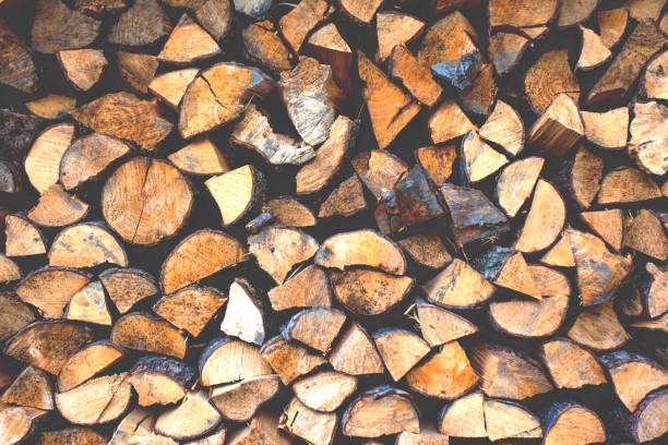 istock a bundle of firewood for the winter, background, texture, retro toned 1130195210