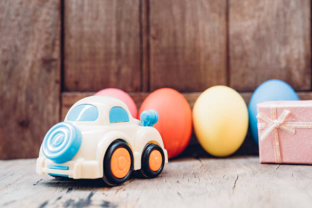 istock Easter egg and toy car on wooden background 1130205502