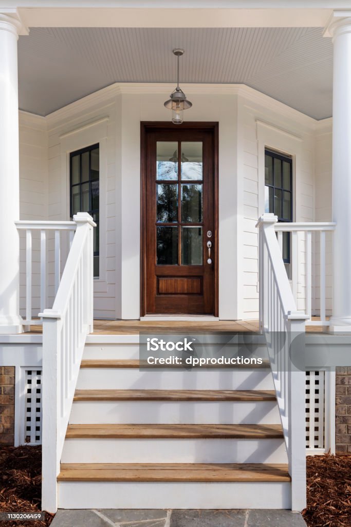 exterior of a house showing the front door Steps leading up to the entryway Steps Stock Photo