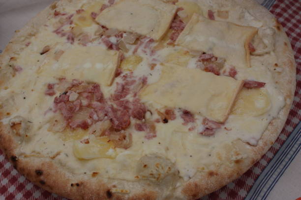 istock Frozen semi-cooked pizza  Savoyard pizza with tartiflette 1130211142