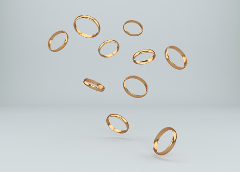 Abstract  composition with flying wedding gold rings. 3D Illustration