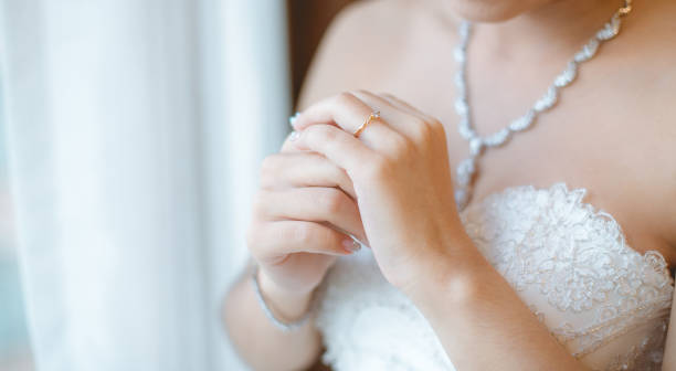 istock Beautiful bride with white wedding dress hold her wedding ring in smooth feeling. 1130214758