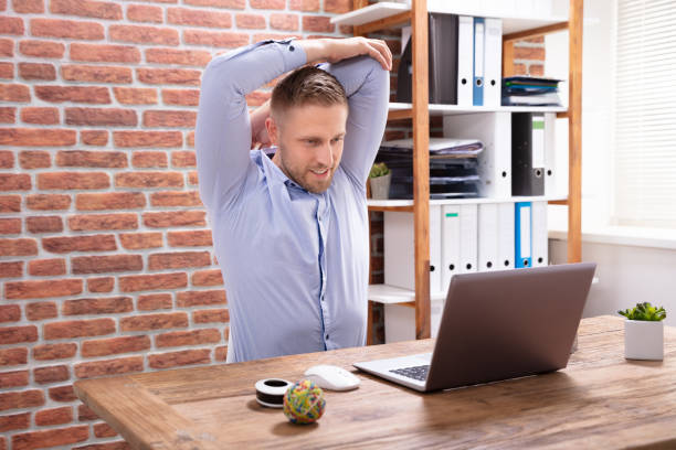 istock Businessman Stretching His Arms At Work Place 1130220044