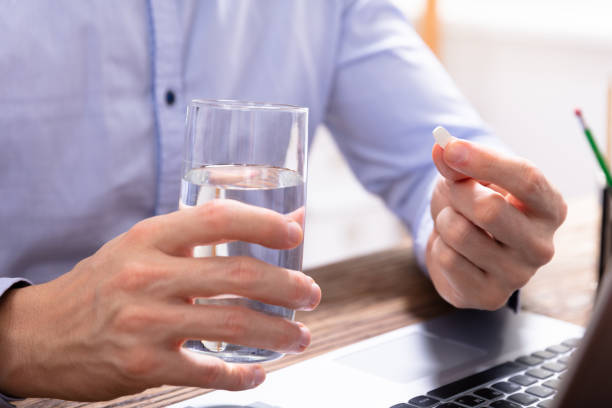 istock Businessman Taking Medicine Pill 1130220046