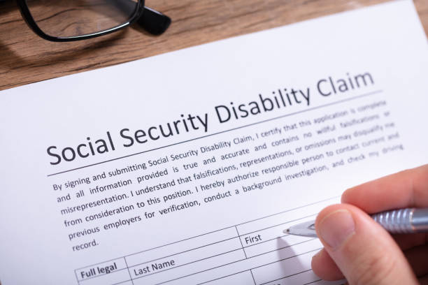 istock Person Filling Social Security Disability Claim Form 1130220069
