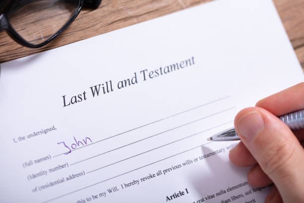 istock Person Filling Last Will And Testament Form 1130220075