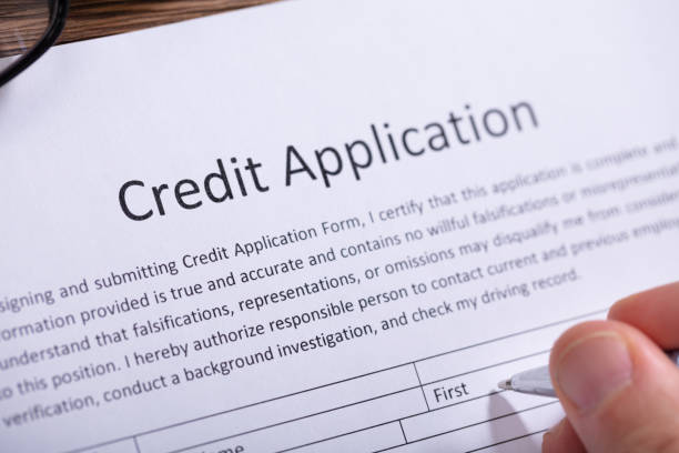 istock Human Hand Filling Credit Application Form 1130220081