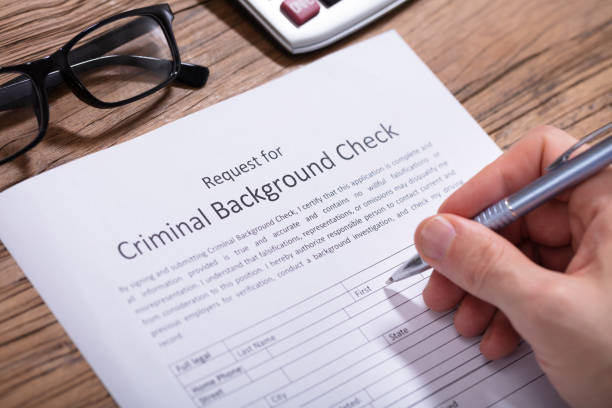 Person Filling Criminal Background Check Form