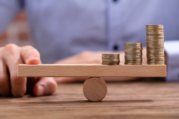 istock Businessman Balancing Stacked Coins With Finger 1130220102