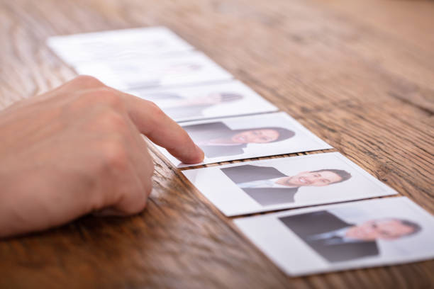 istock Businessperson Selecting Candidate's Photograph 1130220128