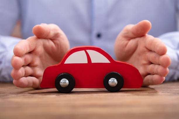 istock Businessman's Hand Protecting Red Toy Car 1130220156