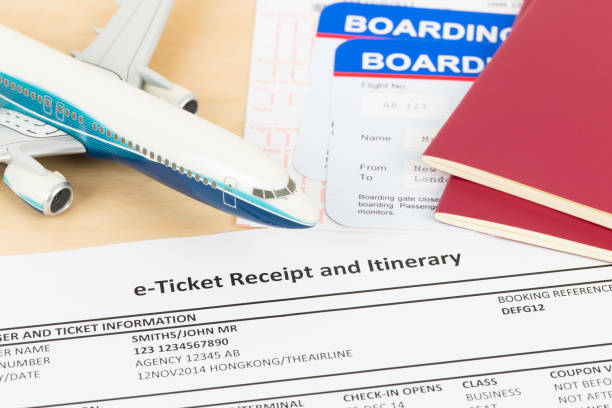 istock E-ticket with plane model red passport, and boarding pass;  these documents are mock-up 1130222126