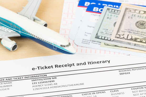 istock E-ticket with plane model, dollar money banknote, and boarding pass; these documents are mock-up 1130222135