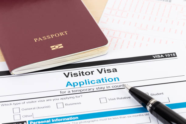 istock Visa application form with red passport and pen 1130222144