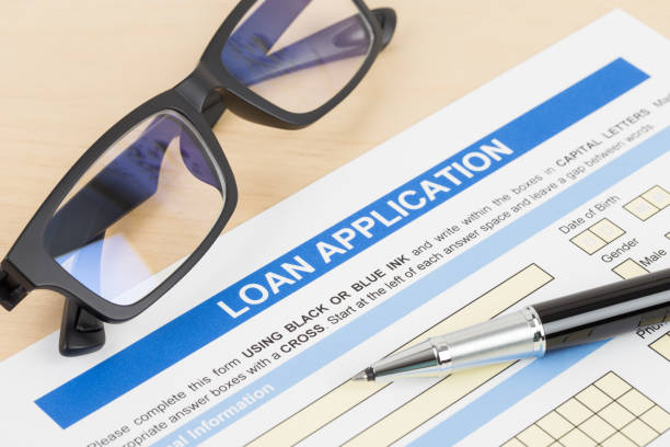 istock Loan application form with glasses, and pen 1130222172