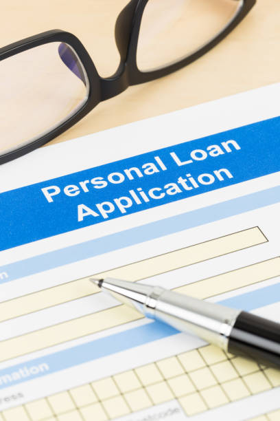 istock Personal loan application form with glasses, and pen 1130222176