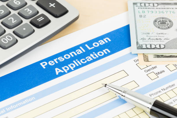 istock Personal loan application form with calculator, dollar money, and pen 1130222180
