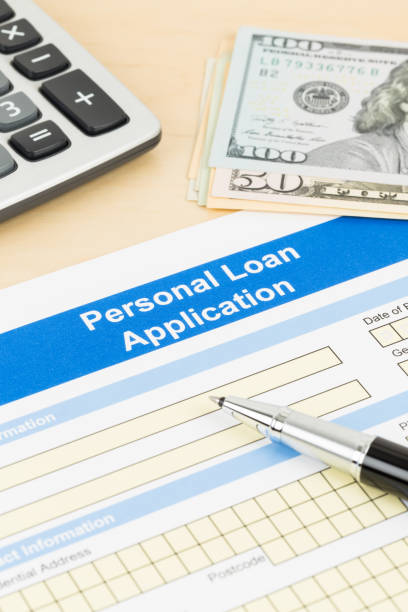 istock Personal loan application form with calculator, dollar money, and pen 1130222181