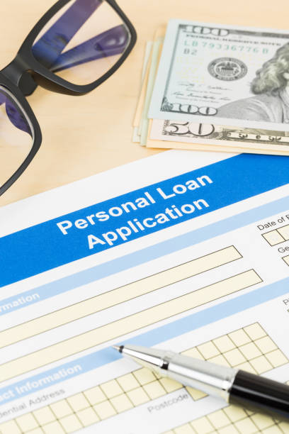 istock Personal loan application form with glasses dollar money, and pen 1130222190