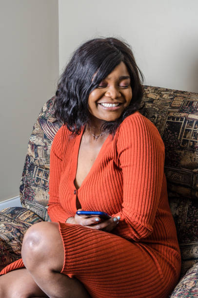 istock Young black woman texting on her mobile phone 1130222226