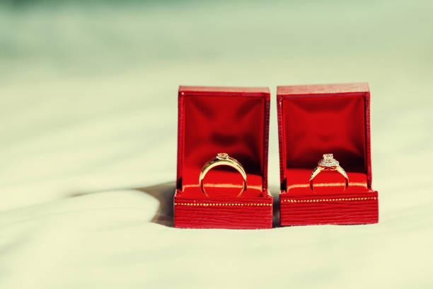 istock Wedding couple diamond rings inside red boxes. 1130222746