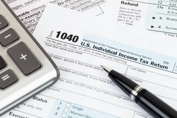 istock Tax form with pen and calculator 1130222757