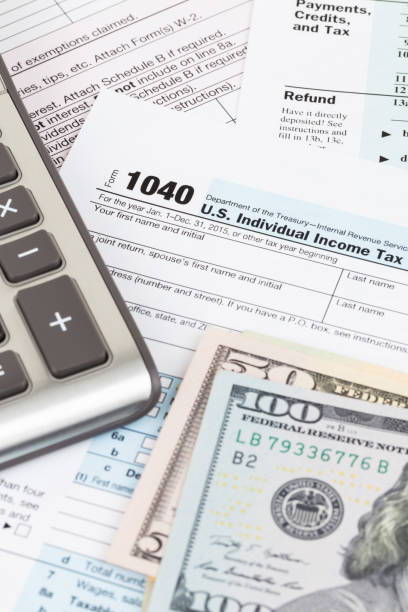 istock Tax form with calculator and dollar banknote 1130222760