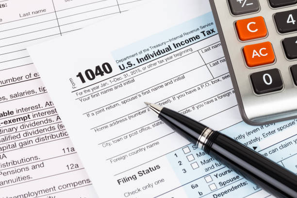 istock Tax form with pen and calculator 1130222762