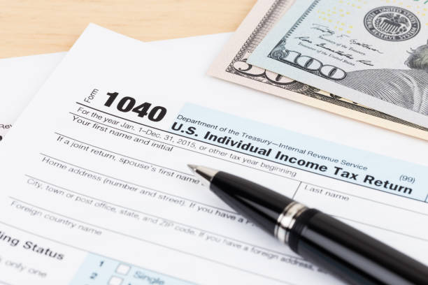 istock Tax form with pen, and dollar banknote 1130222800