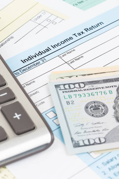 istock Tax form with calculator and dollar banknote; document are mock-up 1130222807