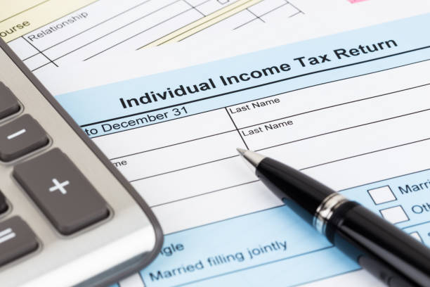 istock Tax form with pen and calculator; document are mock-up 1130222818