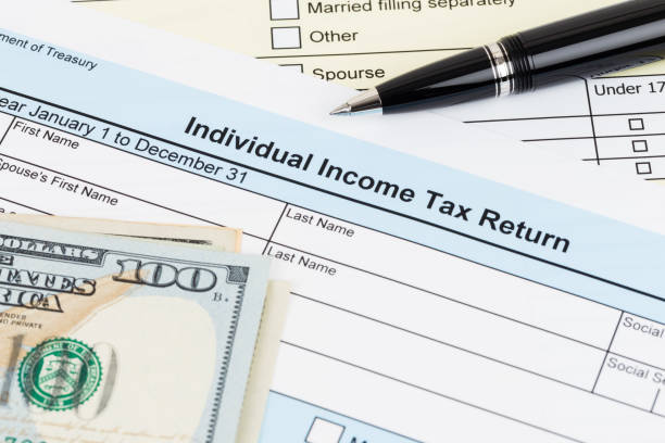 istock Tax form with pen, and dollar banknote; document are mock-up 1130222826