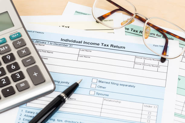 istock Tax form with calculator, pen, and glasses; document are mock-up 1130222909