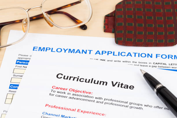 istock Curriculum vitae and employment application form with glasses and neck tie 1130222973