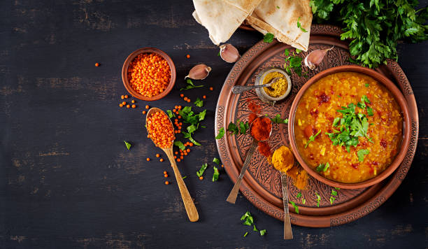 Indian dal. Food. Traditional Indian soup lentils.  Indian Dhal spicy curry in bowl, spices, herbs, rustic black wooden background. Top view. Authentic Indian dish. Overhead. Flat lay Indian dal. Food. Traditional Indian soup lentils.  Indian Dhal spicy curry in bowl, spices, herbs, rustic black wooden background. Top view. Authentic Indian dish. Overhead. Flat lay soup lentil healthy eating dishware stock pictures, royalty-free photos & images