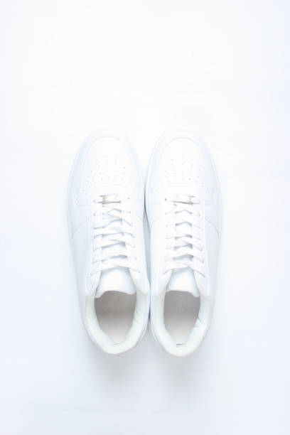 istock Fashionable white sneakers on white background, minimalism, top view, creative layout 1130229280