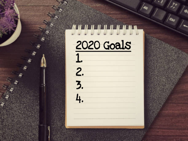 New Year resolutions concept. New Year Goal List on a notepad on wooden table. 2019 new year resolution stock pictures, royalty-free photos & images