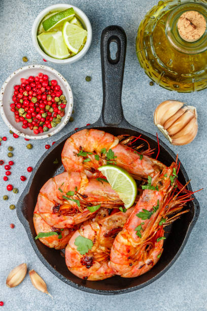 istock Fried king prawns with garlic, pepper, lime and parsley (cilantro). Large shrimp. Langoustine. Selective focus 1130230822