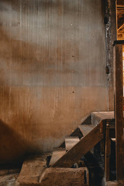 istock Old wooden staircase and cement wall 1130237147