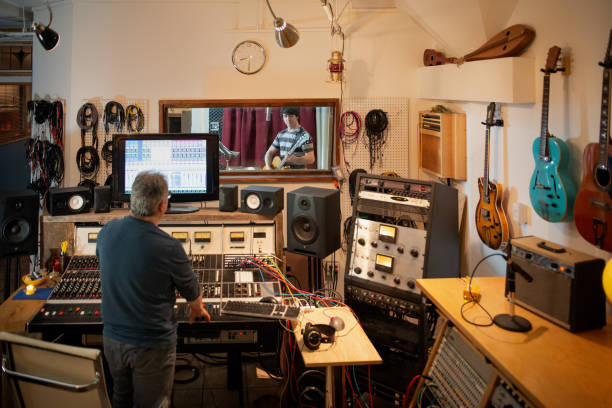 istock Musician Playing Guitar, Engineer Recording in Analog Sound Studio 1130238065
