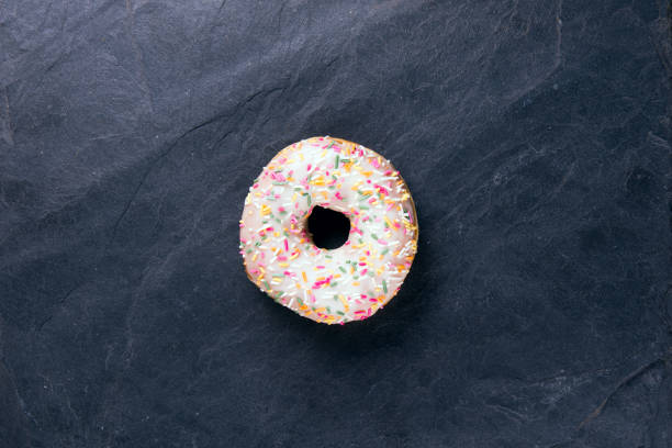 istock fresh donut with toppings on a dark background 1130239259