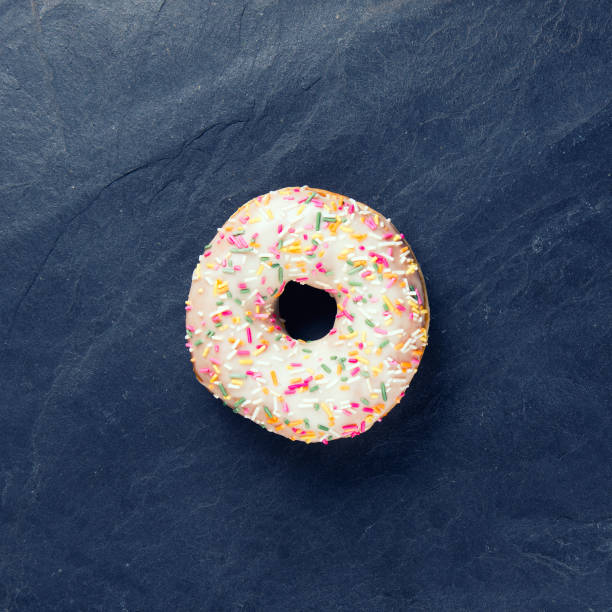 istock fresh donut with toppings on a dark background 1130239357