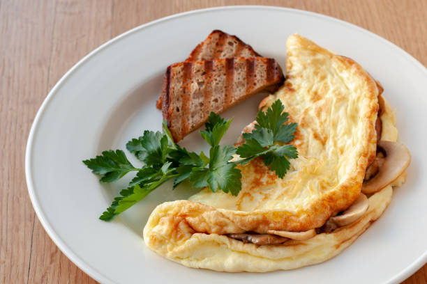 istock Omelet with mushrooms, decorated with herbs and toast. 1130241899