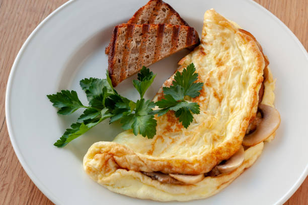 istock Omelet with mushrooms, decorated with herbs and toast. 1130241902