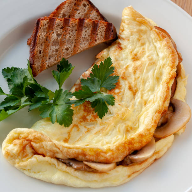 istock Omelet with mushrooms, decorated with herbs and toast. 1130241903
