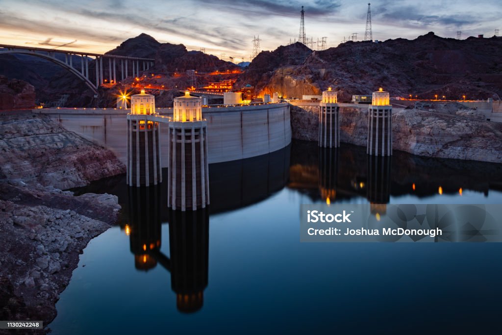 Hoover Dam at Sunset Nevada Arizona Hoover Dam at Lake Mead at night on the border of Nevada and Arizona in southwestern United States is considered the eigth wonder of the world. Arizona Stock Photo